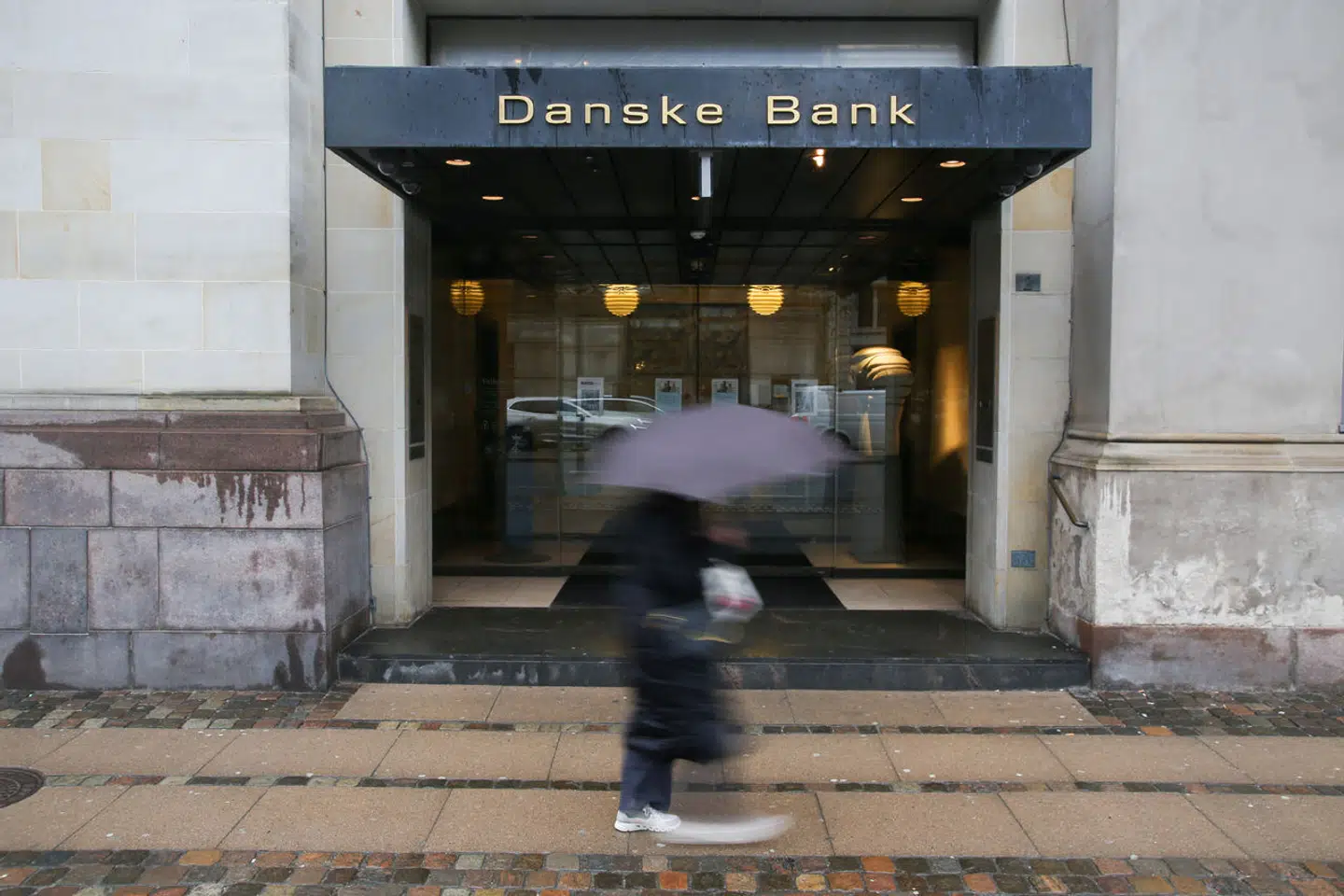A pedestrian walks past a branch of Danske Bank in Copenhagen, Denmark, February 2, 2024. REUTERS/Tom Little