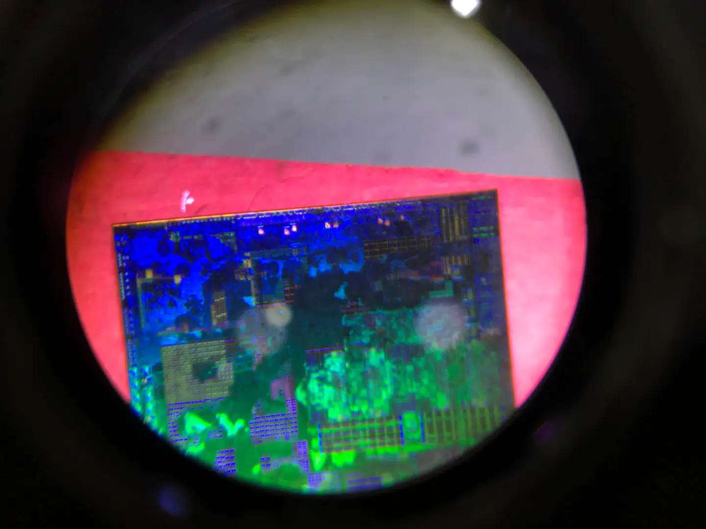 A Chinese microchip is seen through a microscope set up at the booth for the state-controlled Tsinghua Unigroup project which is driving China's semiconductor ambitions during the 21st China Beijing International High-tech Expo in Beijing, China, Thursday, May 17, 2018. The Trump administration has threatened to impose tariffs on up to $150 billion in Chinese imports to punish Beijing over trade practices requiring American companies to hand over technology in exchange for access to the Chinese market. China has counterpunched by targeting $50 billion in U.S. products. (AP Photo/Ng Han Guan)
