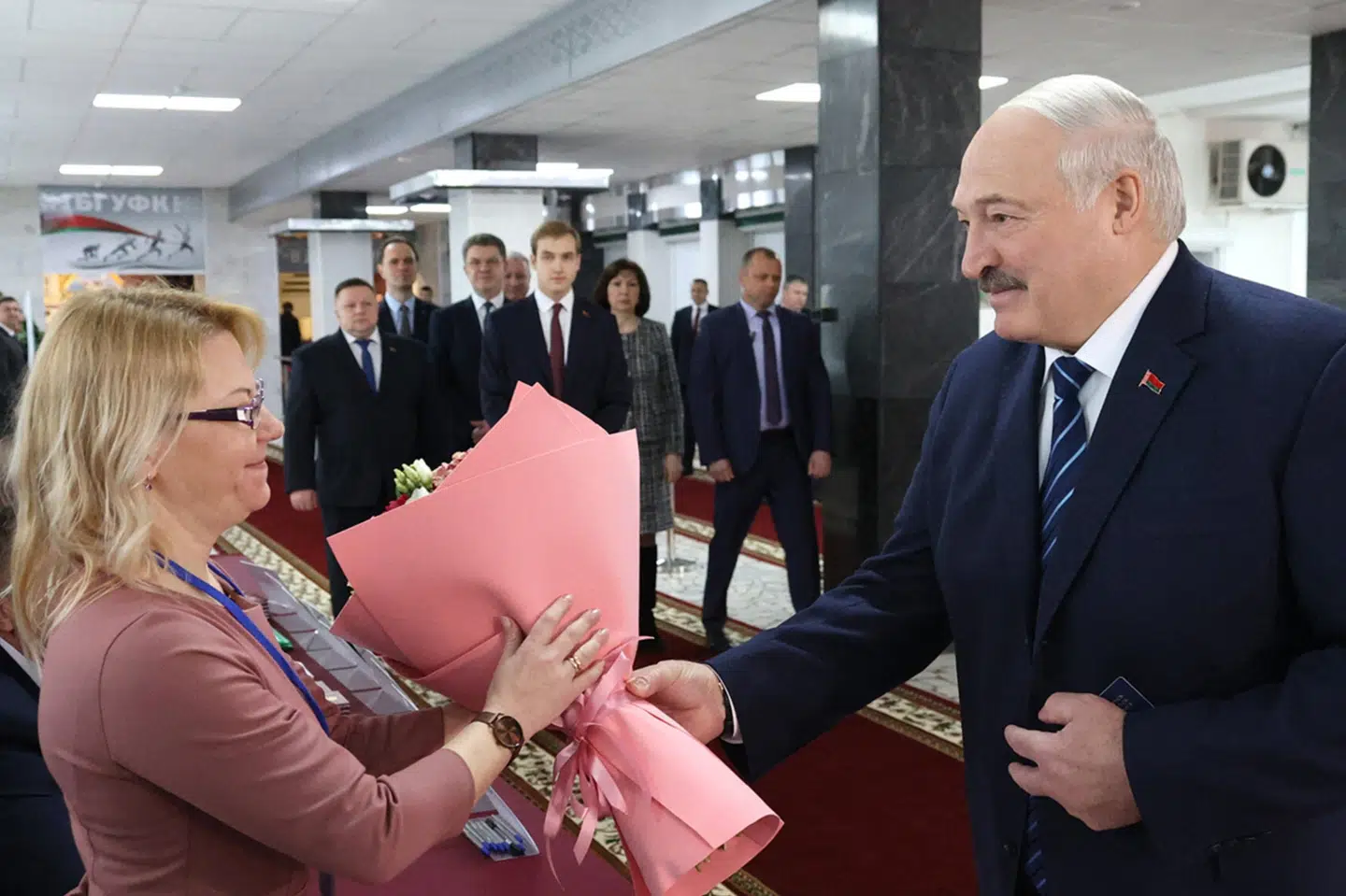 Belarus' autoritære præsident, Aleksandr Lukasjenko, har blomster med til et medlem af valgkommissionen, da han søndag afgiver sin stemme på et valgsted i hovedstaden Minsk. I 2020 var store demonstrationer efter præsidentvalget tæt på at vælte ham, efter han udråbte sig som vinder.