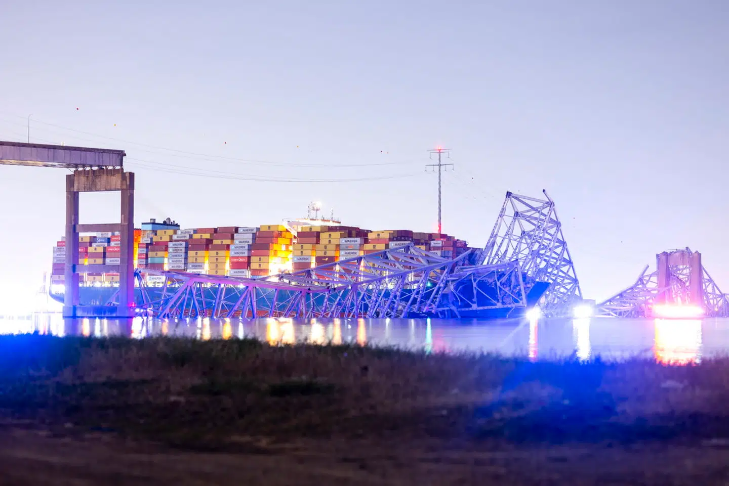 epa11244154 The Francis Scott Key Bridge rests partially collapsed after a container ship ran into it in Baltimore, Maryland, USA, 26 March 2024. The Maryland Department of Transportation confirmed on 26 March that the Francis Scott Key Bridge collapsed due to a ship strike. A 'mass casualty, multi-agency rescue' was underway, according to Kevin Cartwright from the Baltimore City Fire Department. A diving team was trying to locate at least seven people believed to be in the Patapsco River, Cartwright added. EPA/JIM LO SCALZO