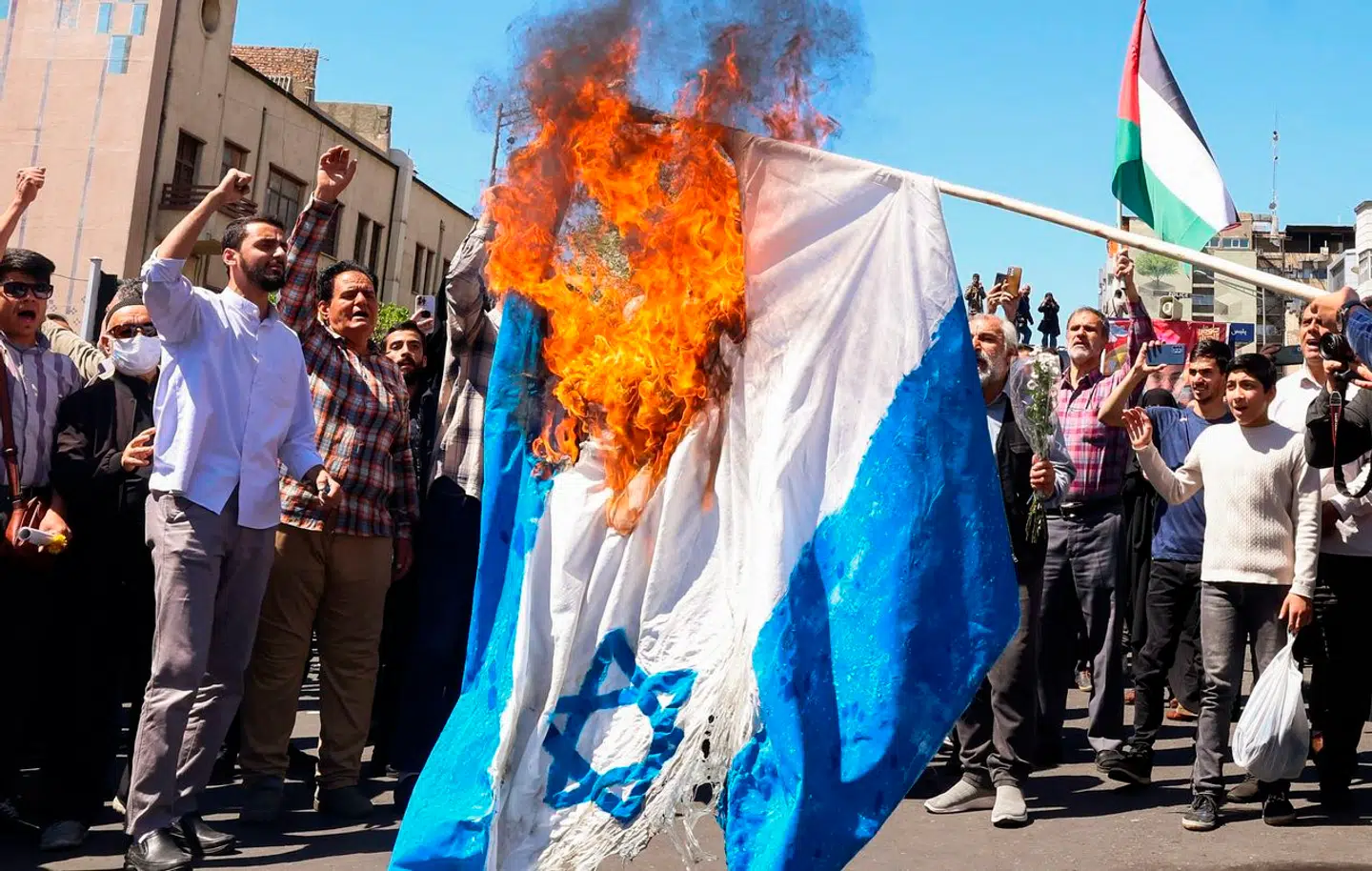 Mens der blev holdt begravelse for medlemmer af den iranske revolutionsgarde, der mistede livet i et angreb 1. april, brændte demonstranter et israelsk flag af.