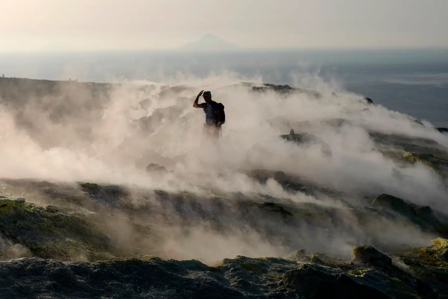 A tourist walks in the fumaroles of a crater on the volcanic island of Vulcano, one of the Aeolian Islands, in the Tyrrhenian Sea, Italy, on September 19, 2019. VALERY HACHE / AFP