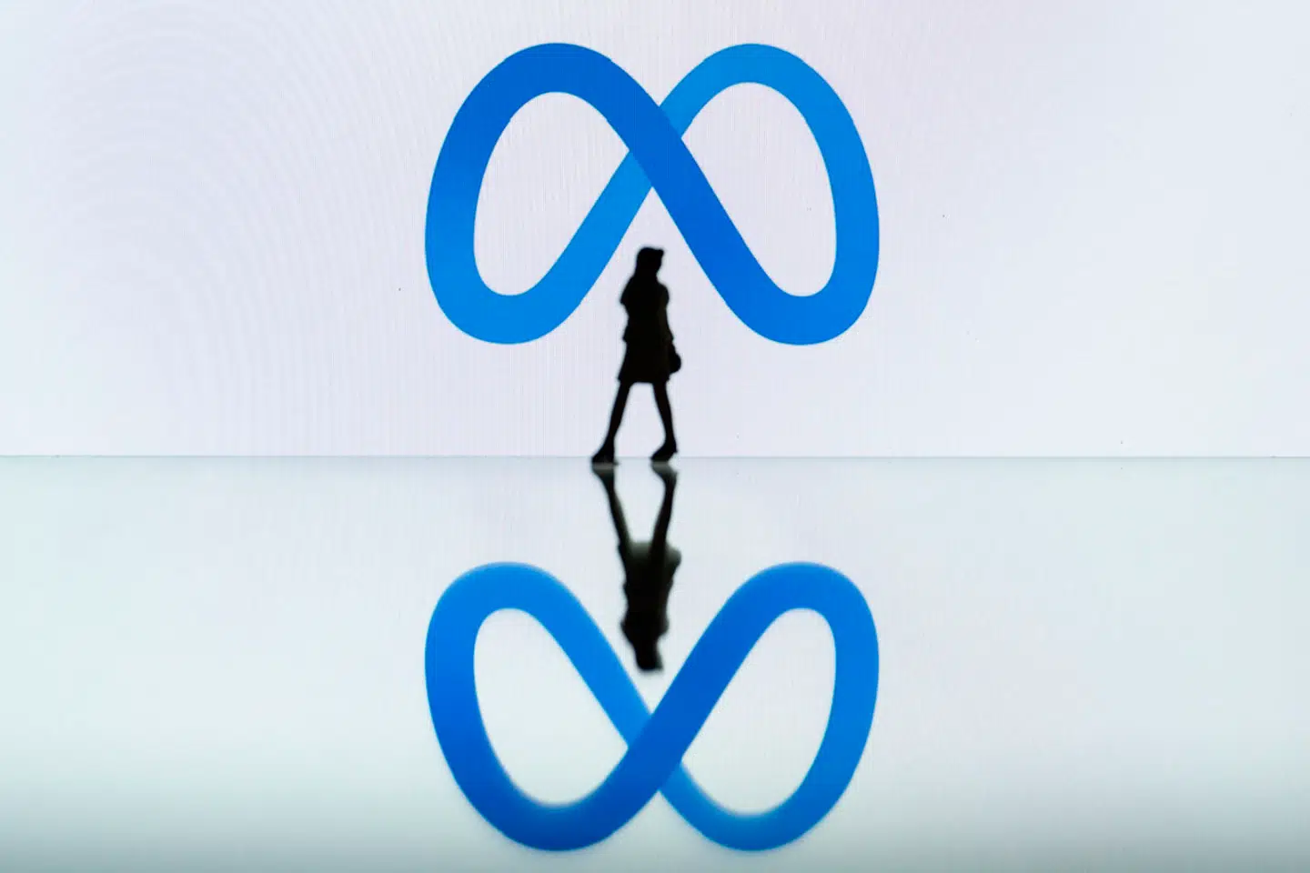 This photograph taken in Mulhouse, eastern France on October 19, 2023, shows a figurine next to the Meta logo. SEBASTIEN BOZON / AFP