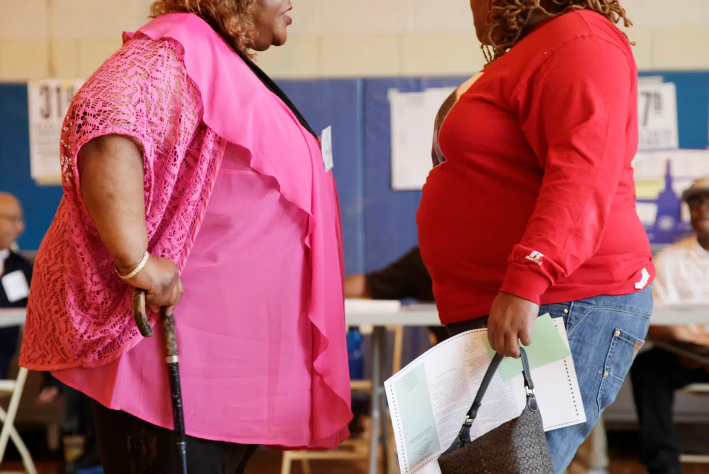 Two overweight women hold a conversation, Tuesday, June 26, 2012 in New York. Two-thirds of American adults are either overweight or obese and some 17 percent of children and teens are obese. Body mass index signals if you're overweight, obese or just right considering your height. Some doctors have begun calling it a vital sign, as crucial to monitor as blood pressure. (AP Photo/Mark Lennihan)