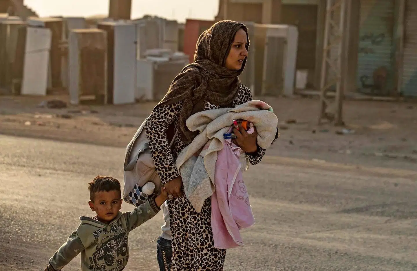 En kvinde flygter med sine børn.