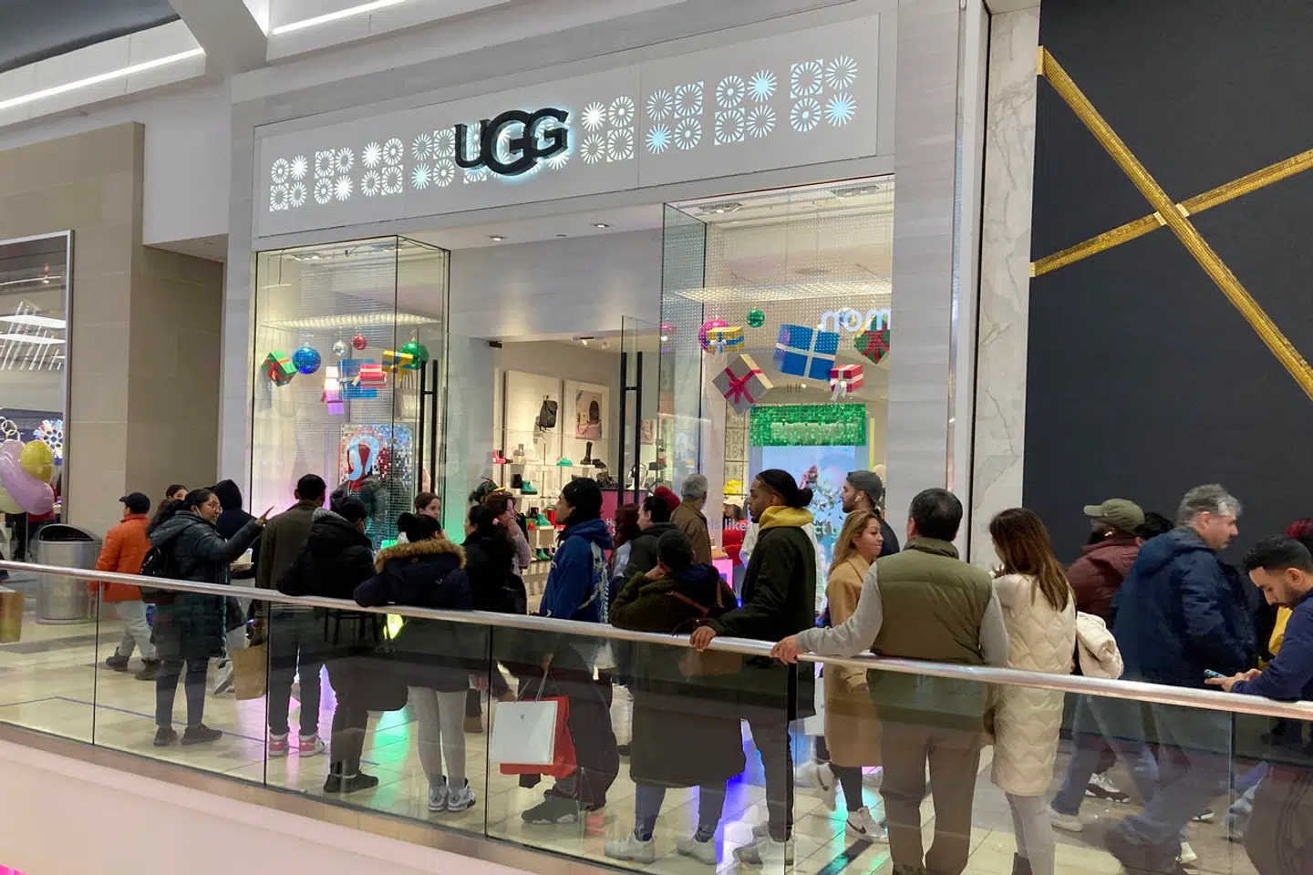 People line up to enter an Ugg store at the Westfield Graden State Plaza shopping mall in Paramus, New Jersey, on Saturday, December 17, 2022. (AP Photo/Ted Shaffrey)
