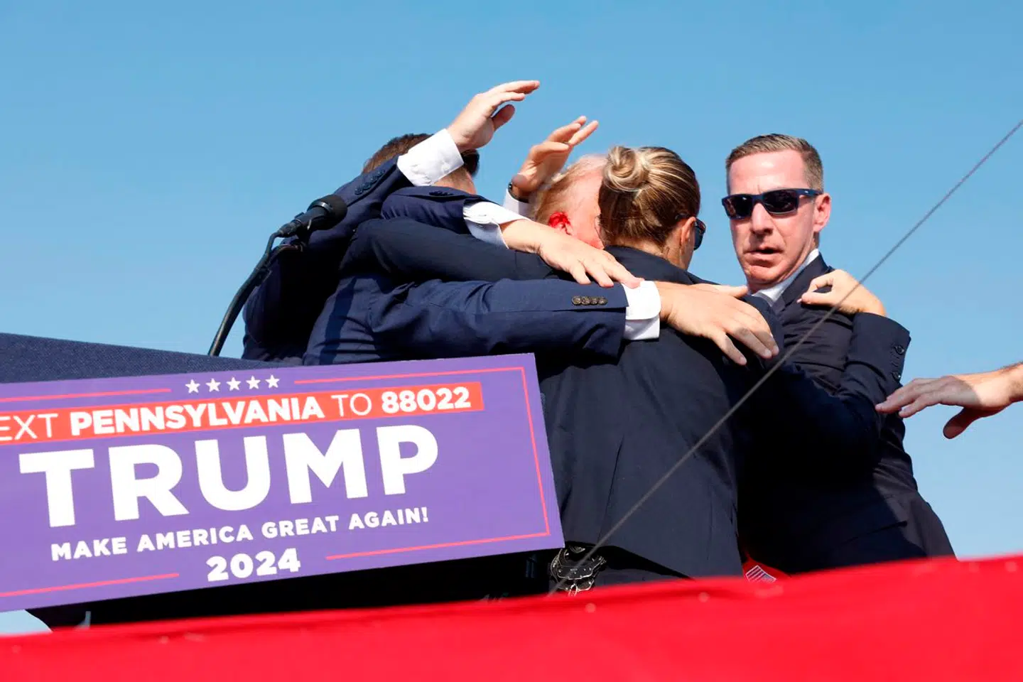 Secret Service-agenter fik hurtigt ført Trump væk fra scenen.