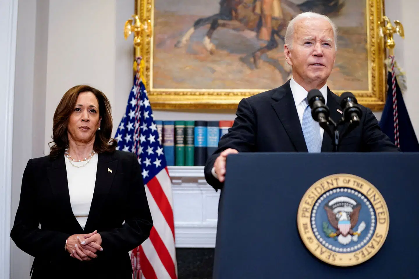 FILE PHOTO: U.S. President Joe Biden speaks next to Vice President Kamala Harris as he delivers a statement a day after Republican challenger Donald Trump was shot at a campaign rally, during brief remarks at the White House in Washington, U.S., July 14, 2024. REUTERS/Nathan Howard/File Photo
