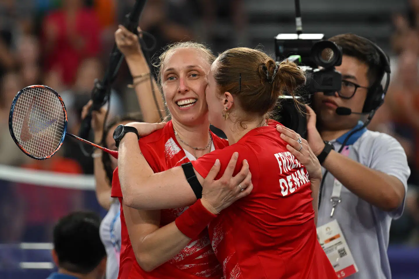 Maiken Fruergaard kysser sin makker Sara Thygesen efter mandagens vildeste OL-drama set med danske øjne. Parret er overraskende klar til kvartfinalerne som gruppevinder.