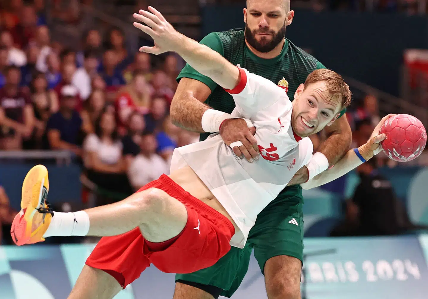 Paris 2024 Olympics - Handball - Men's Preliminary Round Group B - Hungary vs Denmark - South Paris Arena 6, Paris, France - August 02, 2024. Adrian Sipos of Hungary in action with Mathias Gidsel of Denmark REUTERS/Eloisa Lopez