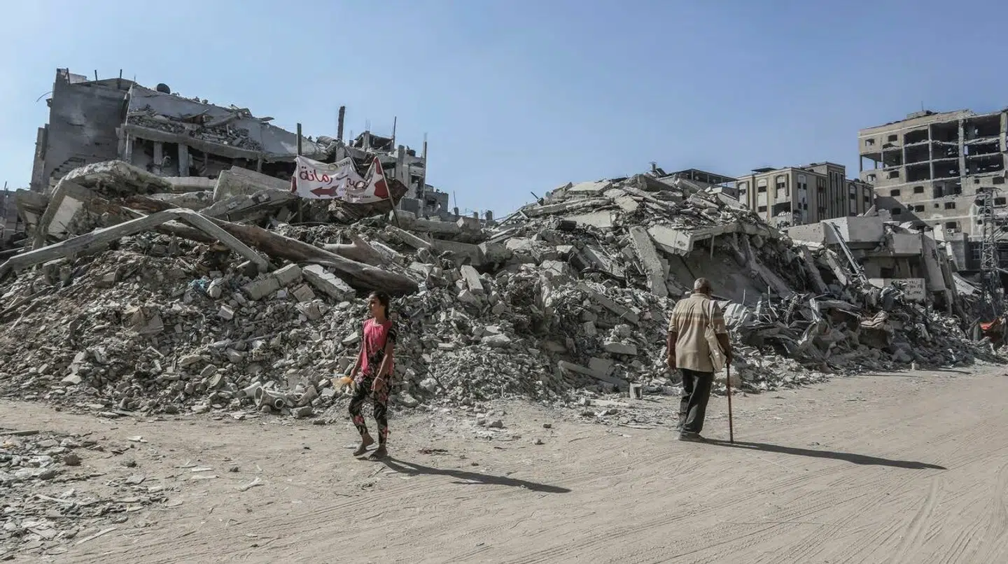 Danske politikere er uenige om, hvorvidt Danmark fortsat skal støtte FNs organisation UNRWA efter det er kommet frem at ni ansatte efter alt at dømme deltog i terrorangrebet mod Israel 7. oktober 2023. Her ses to indbyggere i Gazastriben ved en sønderbombet bygning.