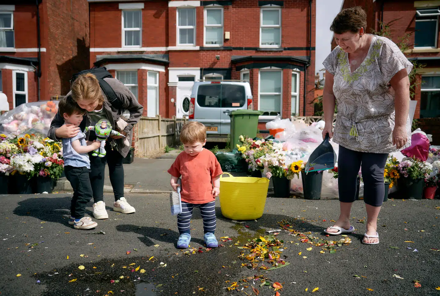 Freddy på fire år og Milo på 13 måneder hjælper med at feje vejen. De bor få huse fra danseskolen, der blev angrebet.