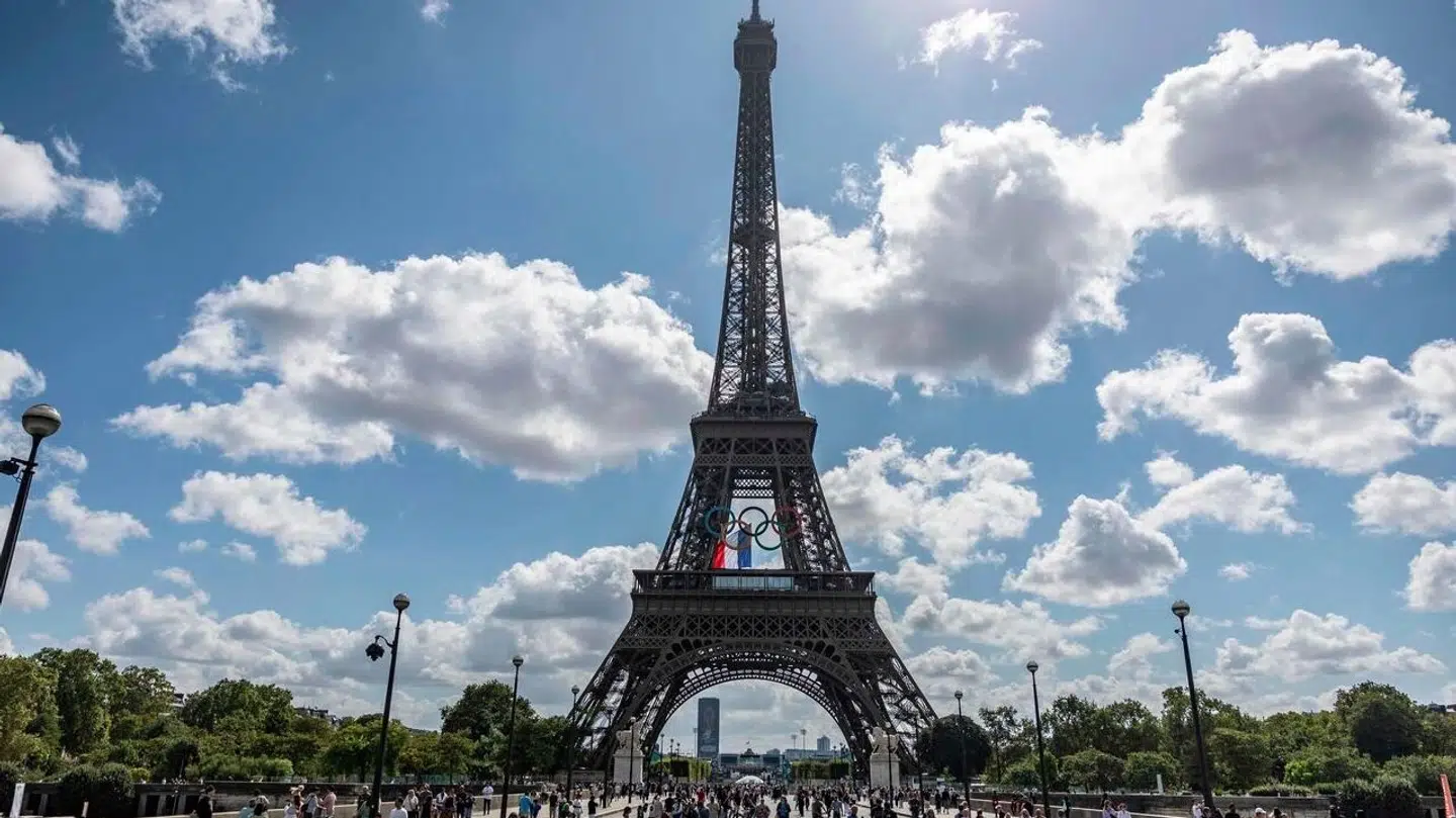A French national flag flutters on the Eiffel Tower behind the Olympic rings following a ceremony commemorating the firemen who raised the French flag on the Eiffel Tower in 1944 after Paris was liberated from the Nazi occupation, in Paris on August 25, 2024. (Photo by Olympia DE MAISMONT / AFP)