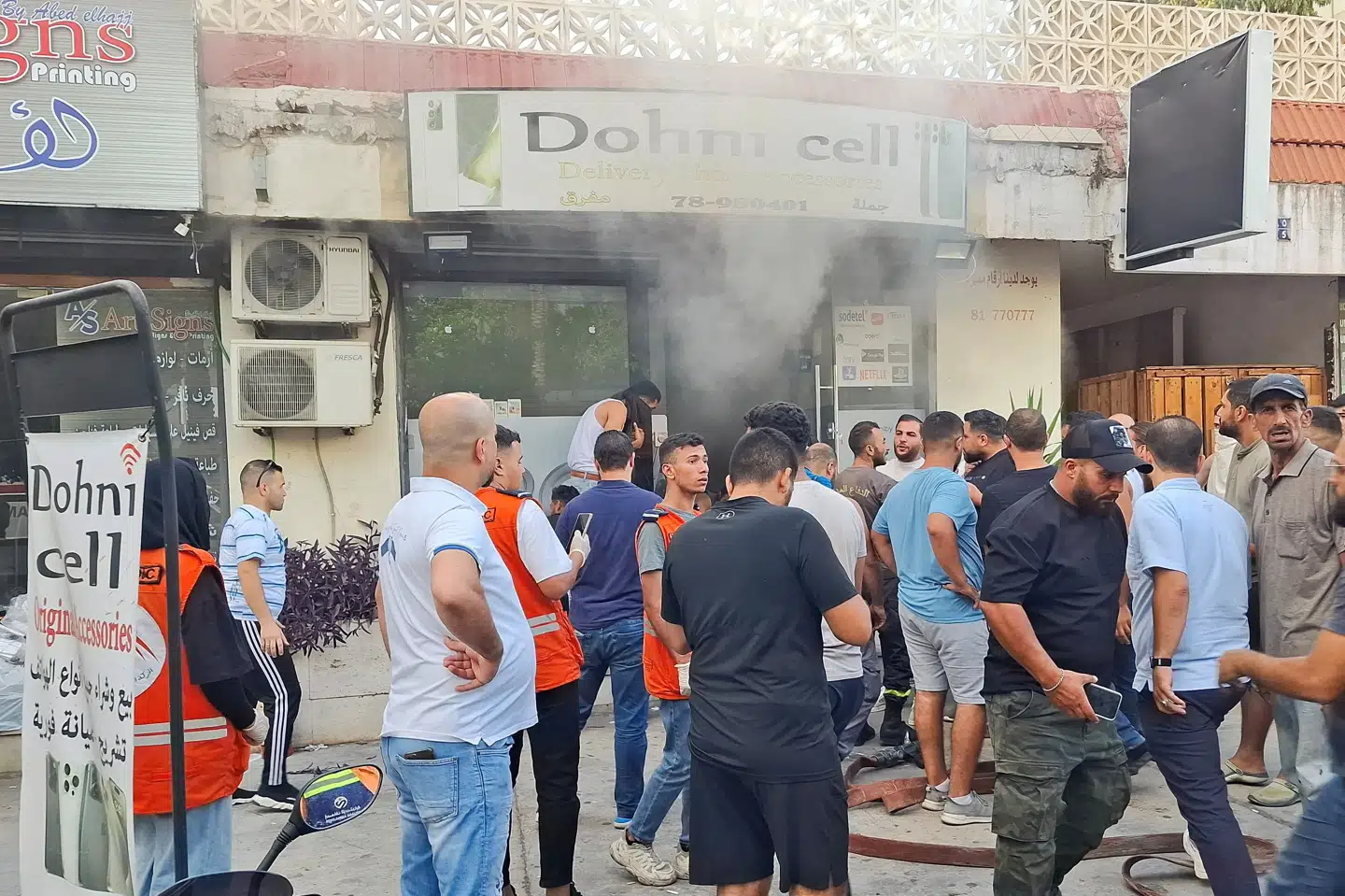 Folk ses onsdag samlet foran en butik, der sælger mobiltelefoner, i den libanesiske by Sidon. Der er onsdag meldinger om nye eksplosioner i kommunikationsudstyr i Libanon.