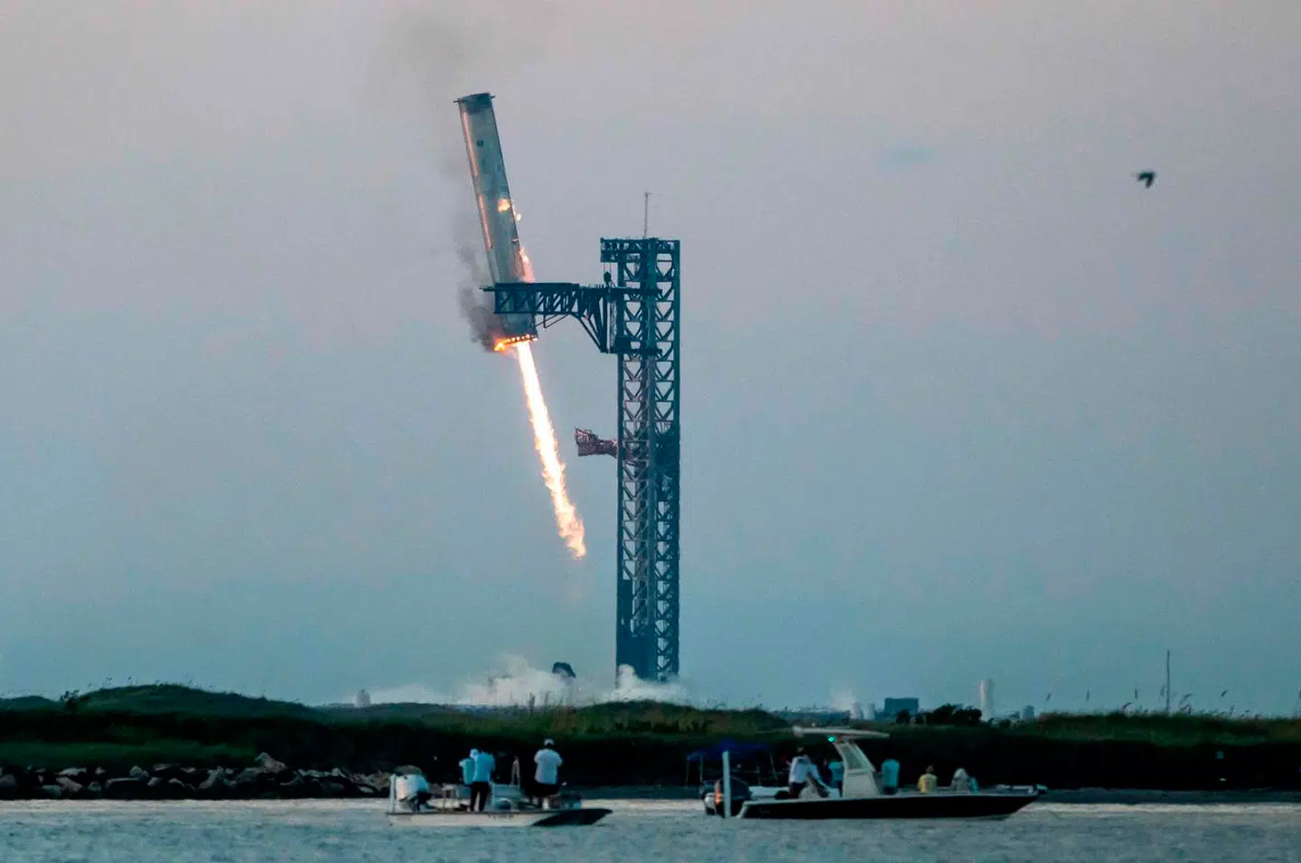 Efter at have sendt en Starship-raket til vejrs lykkedes det SpaceX at styre rakettens nederste del - løfteraketten Super Heavy - tilbage til affyringsrampen, hvor den blev grebet af metaltårnets vældige fangarme. Foto: Sergio Flores, Scanpix