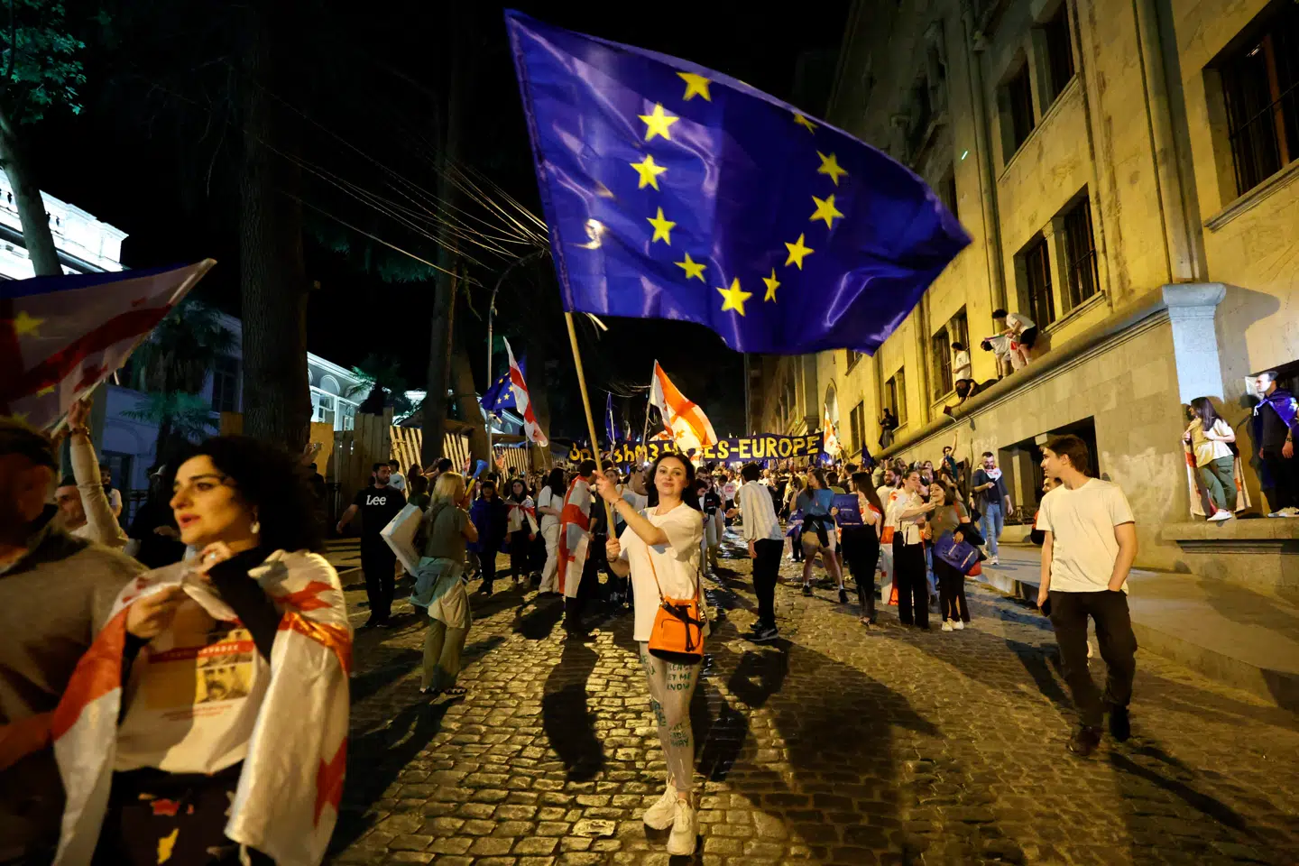 TOPSHOT - A woman waves a EU flag during a protest against a controversial "foreign influence" bill, which Brussels warns would undermine Georgia's European aspirations, in Tbilisi on April 28, 2024. (Photo by Giorgi ARJEVANIDZE / AFP)