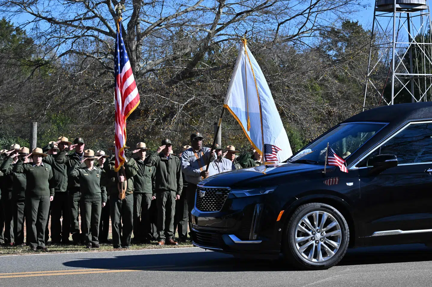 En klokke ringede 39 gange og de ansatte i National Park Service gjorde honnør, da den sorte rustvogn med ekspræsidentens kiste stoppede ud for Boyhood Farm, hvor Jimmy Carter voksede op i den lille by Plains i Georgia.