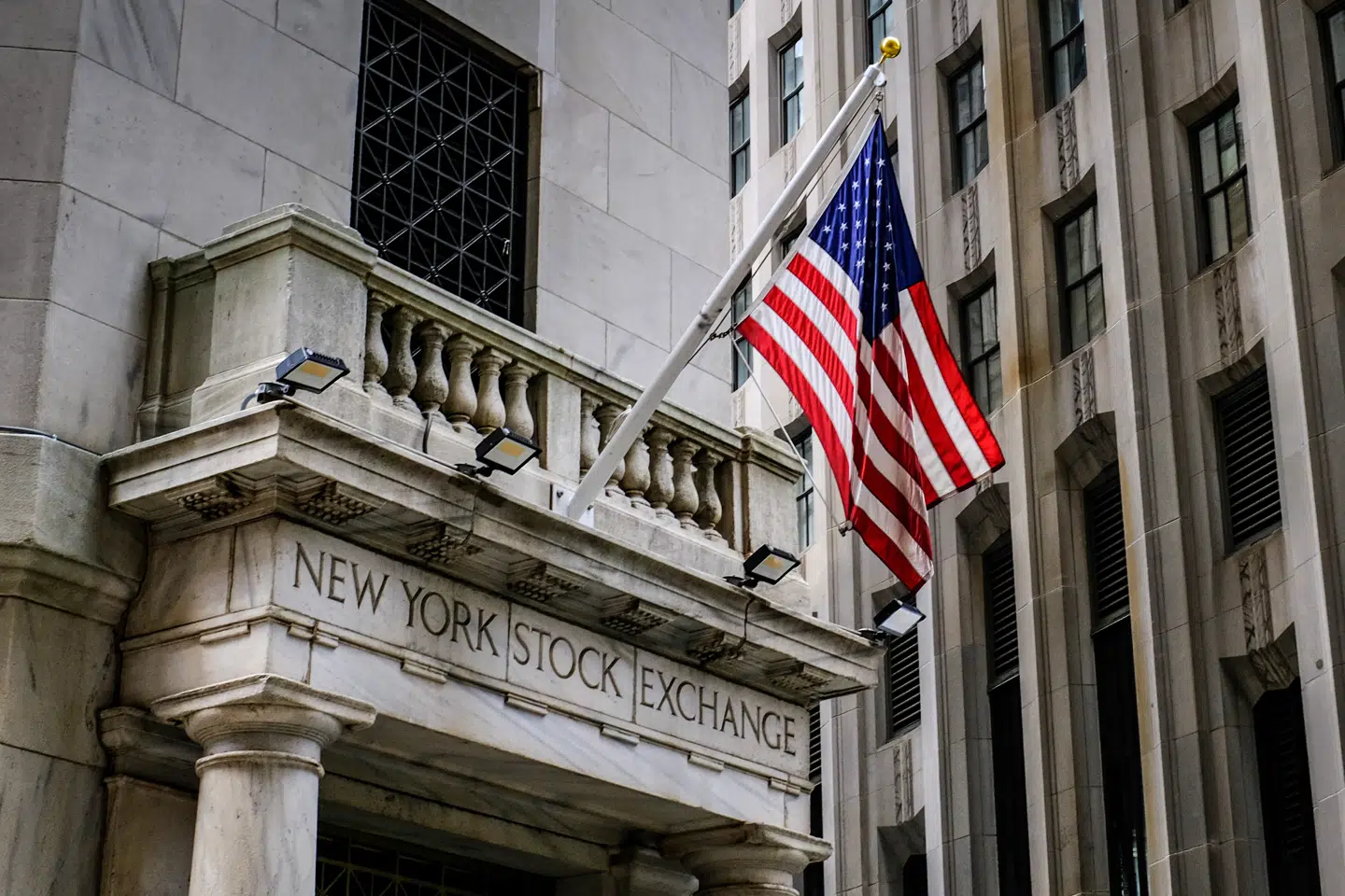 The U.S. flag flies over the side entrance to the New York Stock Exchange in New York Tuesday, July 18, 2023. A strong stock market turnaround is helping spur a resurgence in companies going public a year after the number of Wall Street newcomers fell to the lowest level since the Great Recession. Some 55 initial public offerings, or IPOs, have priced so far this year, raising $9.7 billion in proceeds, according to IPO tracker Renaissance Capital. (AP Photo/J. David Ake)