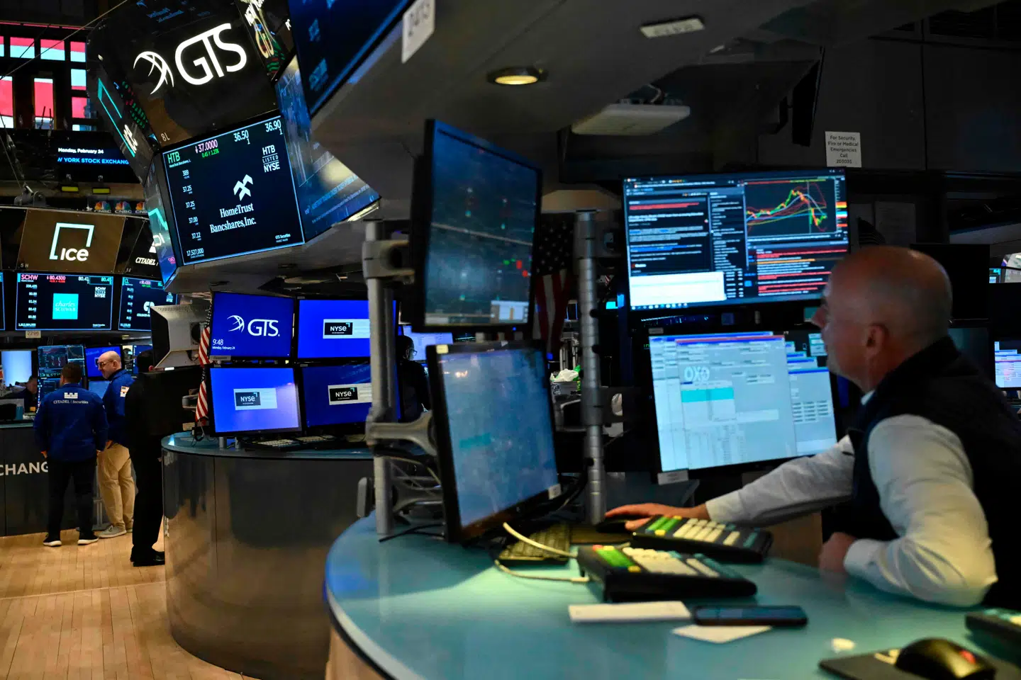 Traders work on the floor of the New York Stock Exchange (NYSE) following the opening bell in New York City on February 24, 2025. (Photo by ANGELA WEISS / AFP)