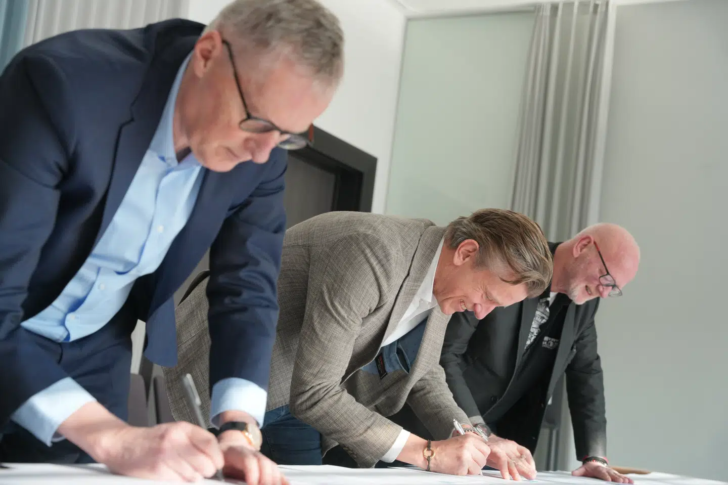 Laurits Rønn, viceadministrerende direktør i Dansk Erhverv, Mads Friis, formand i Horesta og John Frederiksen, formand for 3F Privat Service, Hotel og Restauration, underskriver en aftale om ny overenskomst fredag.