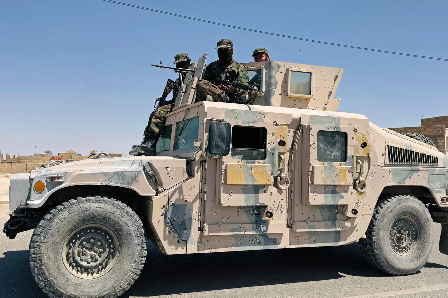 Taliban-folk patruljerer langs en vej i Zaranj efter offentlig henrettelse af en mand på et fodboldstadion.