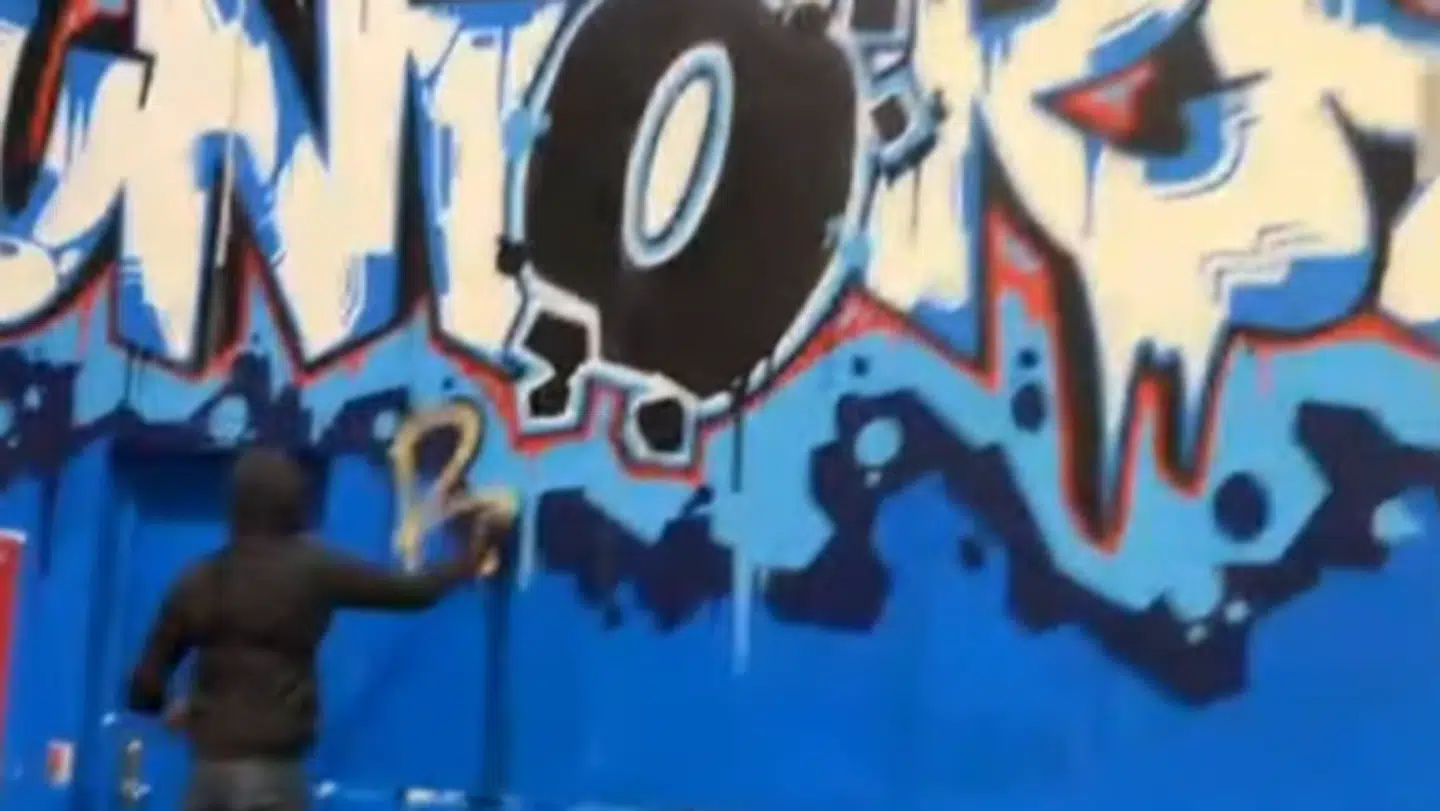 Her kan man se en person male graffiti under B-tribunen.