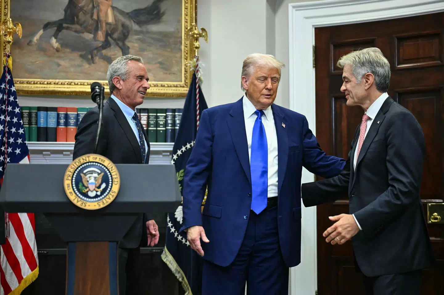 På et pressemøde var USA's præsident, Donald Trump (i midten), flankeret af Mehmet Oz, der leder Medicare og Medicaid, til højre og sundhedsminister Robert F. Kennedy Jr. til venstre.