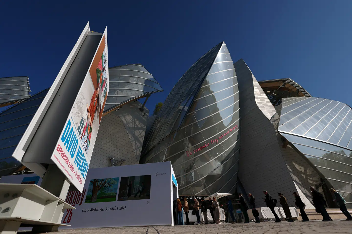 Det er her i arkitekten Frank Gehrys dekonstruktive tjubang-bygning til Fondation Louis Vuitton, at man kan se den kæmpestore og meget fascinerende David Hockney-udstilling