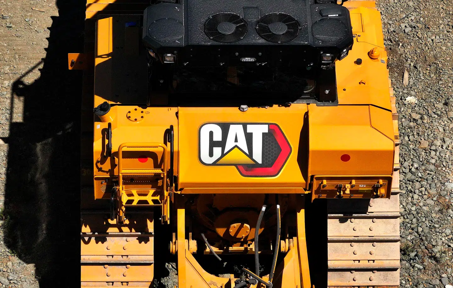SAN LEANDRO, CALIFORNIA - AUGUST 05: In an aerial view, the Caterpillar logo is displayed on a Caterpillar tractor that sits parked in a lot at Peterson Cat on August 05, 2025 in San Leandro, California. Heavy equipment maker Caterpillar reported second-quarter earnings that showed a 21 percent decline in profits, as the company deals with unfavorable manufacturing costs resulting from higher tariffs. Justin Sullivan/Getty Images/AFP (Photo by JUSTIN SULLIVAN / GETTY IMAGES NORTH AMERICA / Getty Images via AFP)