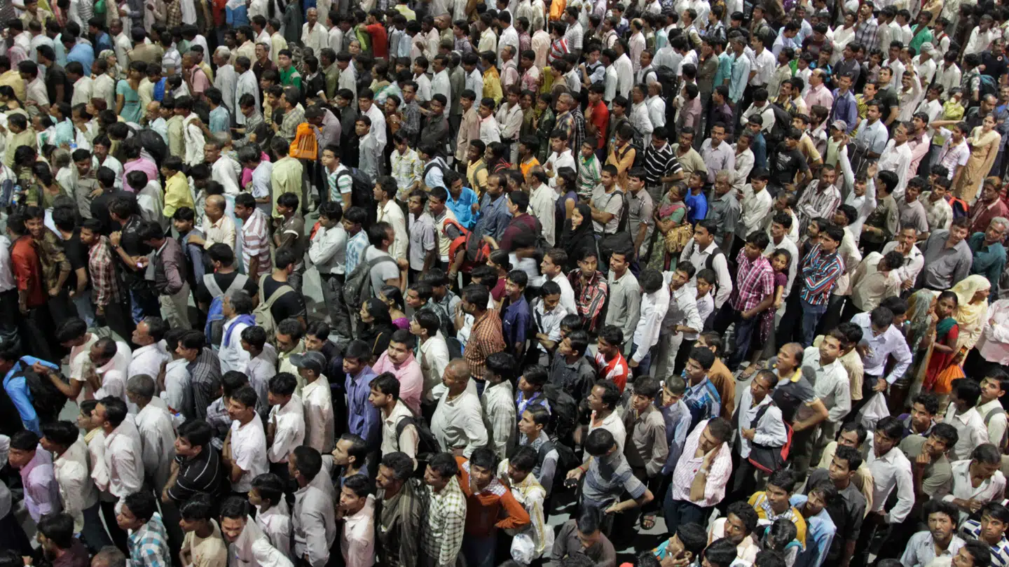 FILE - Indians crowd ticket counters at a railway station in Ahmadabad. (AP Photo/Ajit Solanki, File)