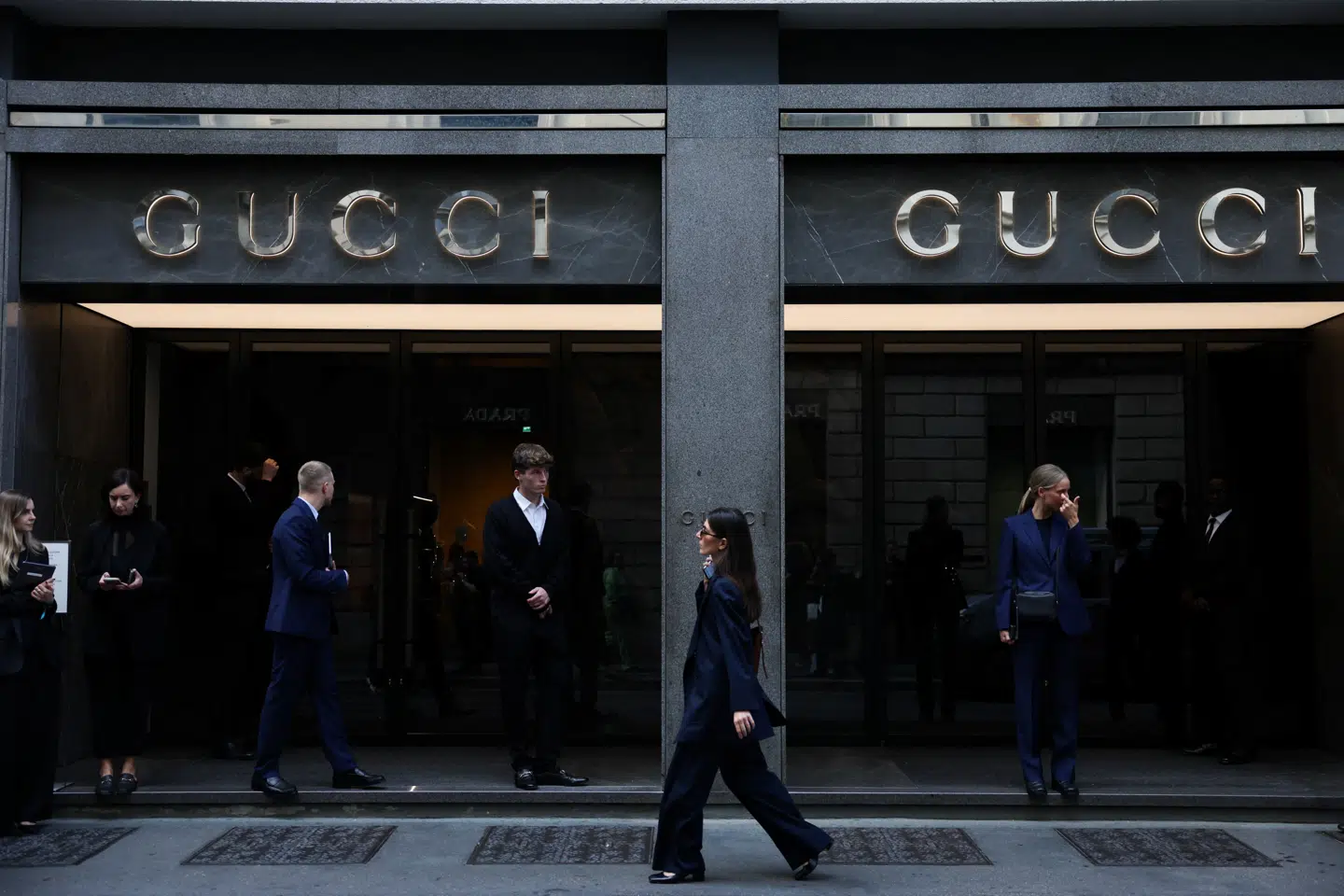 A woman walks past a Gucci store in Milan, Italy, September 24, 2025. REUTERS/Yara Nardi