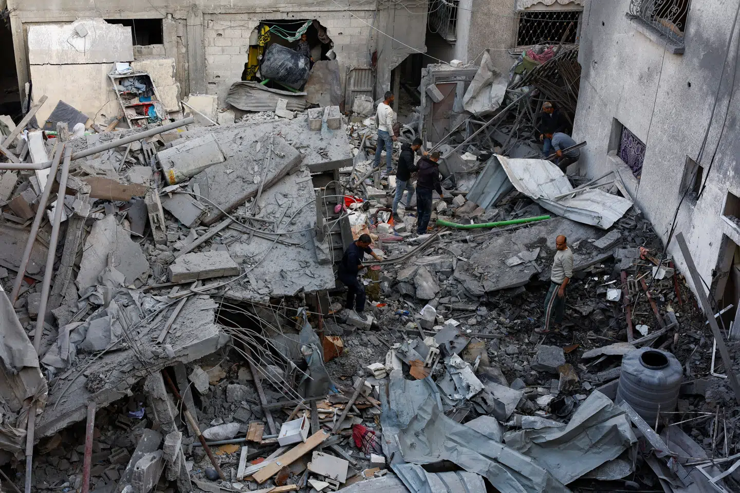 Palæstinensere er søndag ved at inspicere skaderne efter et israelsk angreb i Gaza By dagen inden. Mindst 20 mennesker blev dræbt i forskellige angreb i Gazastriben lørdag.