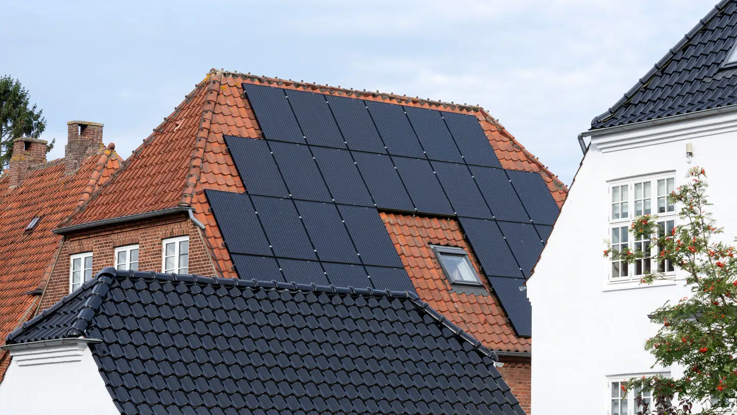 Solcellepaneler monteret på taget af klassisk murermestervilla.