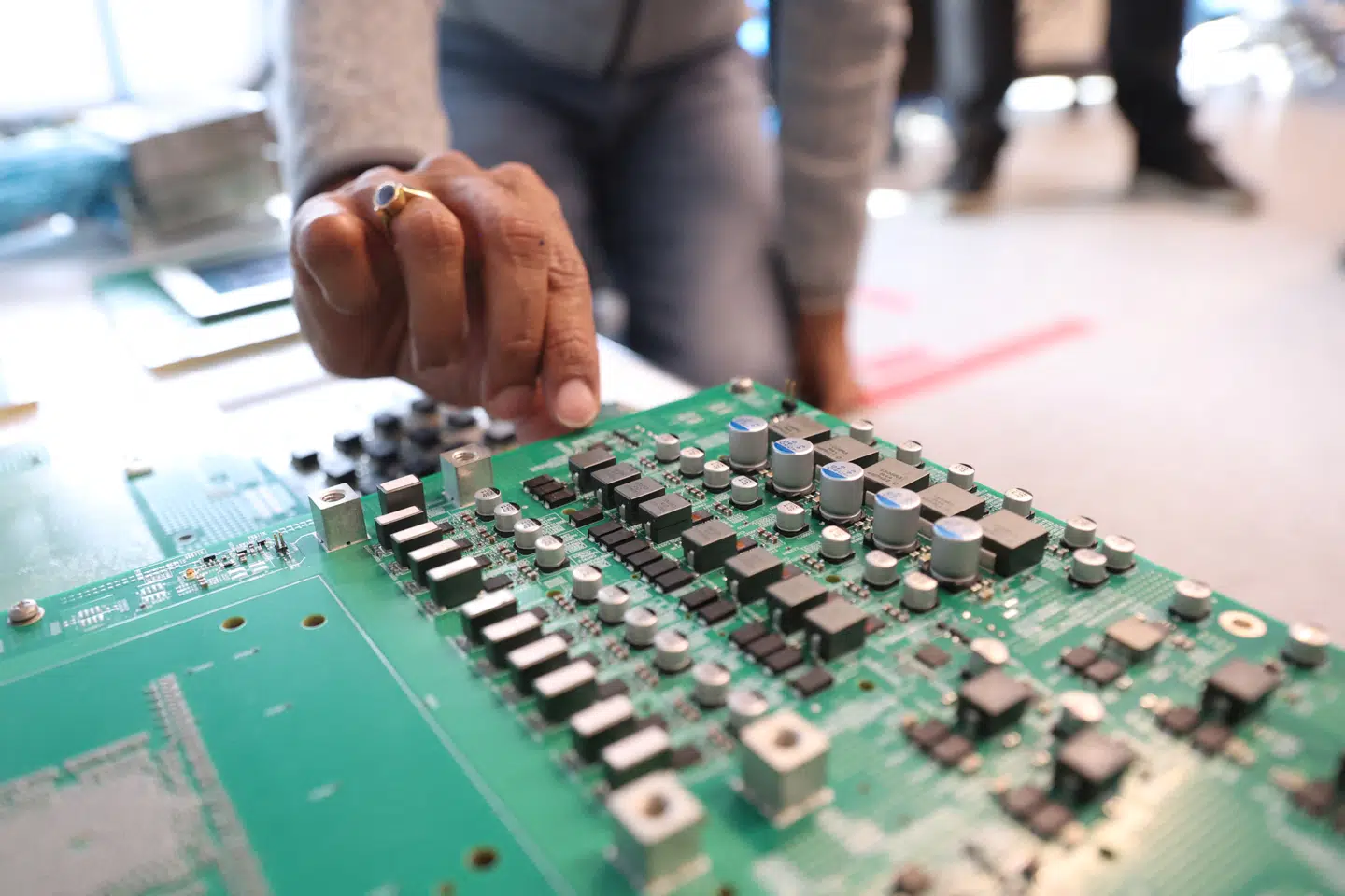 An employee shows circuit boards designed for chip testing as Broadcom prepares to launch new optical chip tech to fend off Nvidia in San Jose, California, U.S., September 5, 2025. REUTERS/Brittany Hosea-Small