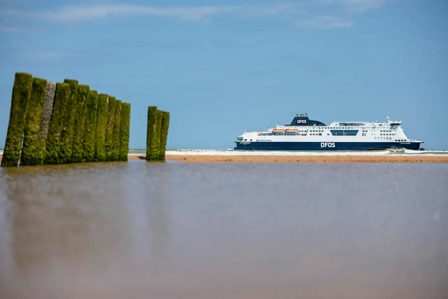 A Danish international shipping and logistics company DFDS ferry sails off the beach of Bleriot in Sangatte, near Calais, northern France on June 11, 2025. (Photo by Sameer Al-DOUMY / AFP)