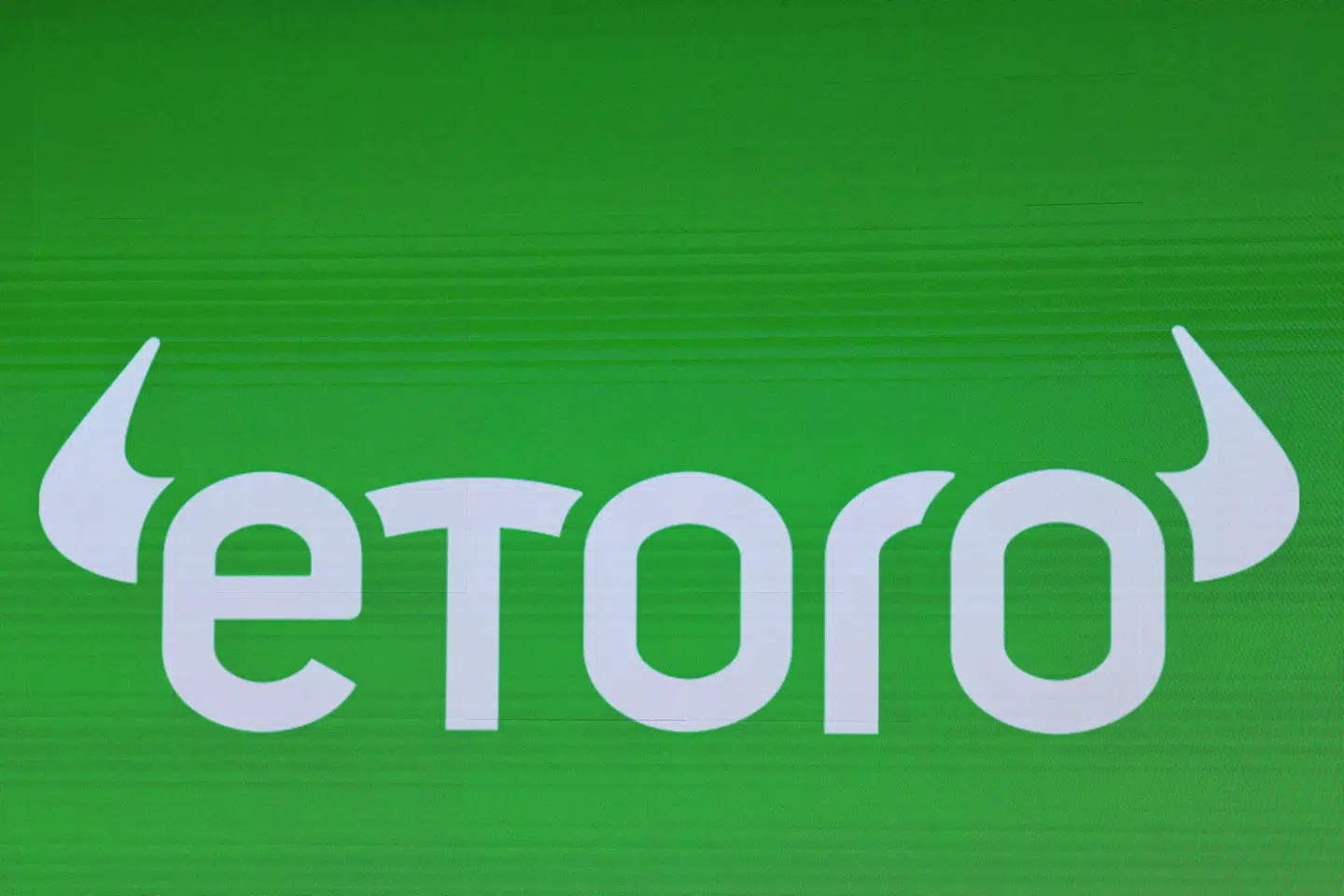 FILE PHOTO: The eToro logo is displayed on a screen during the company's IPO at the Nasdaq Market, in New York City, U.S., May 15, 2025. REUTERS/Brendan McDermid/File Photo