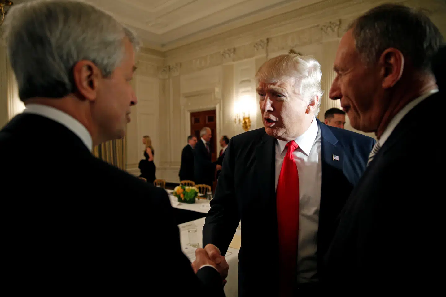 U.S. President Donald Trump shakes hands with JPMorgan Chase & Co CEO Jamie Dimon (L) as he hosts a strategy and policy forum with chief executives of major U.S. companies at the White House in Washington February 3, 2017. REUTERS/Kevin Lamarque