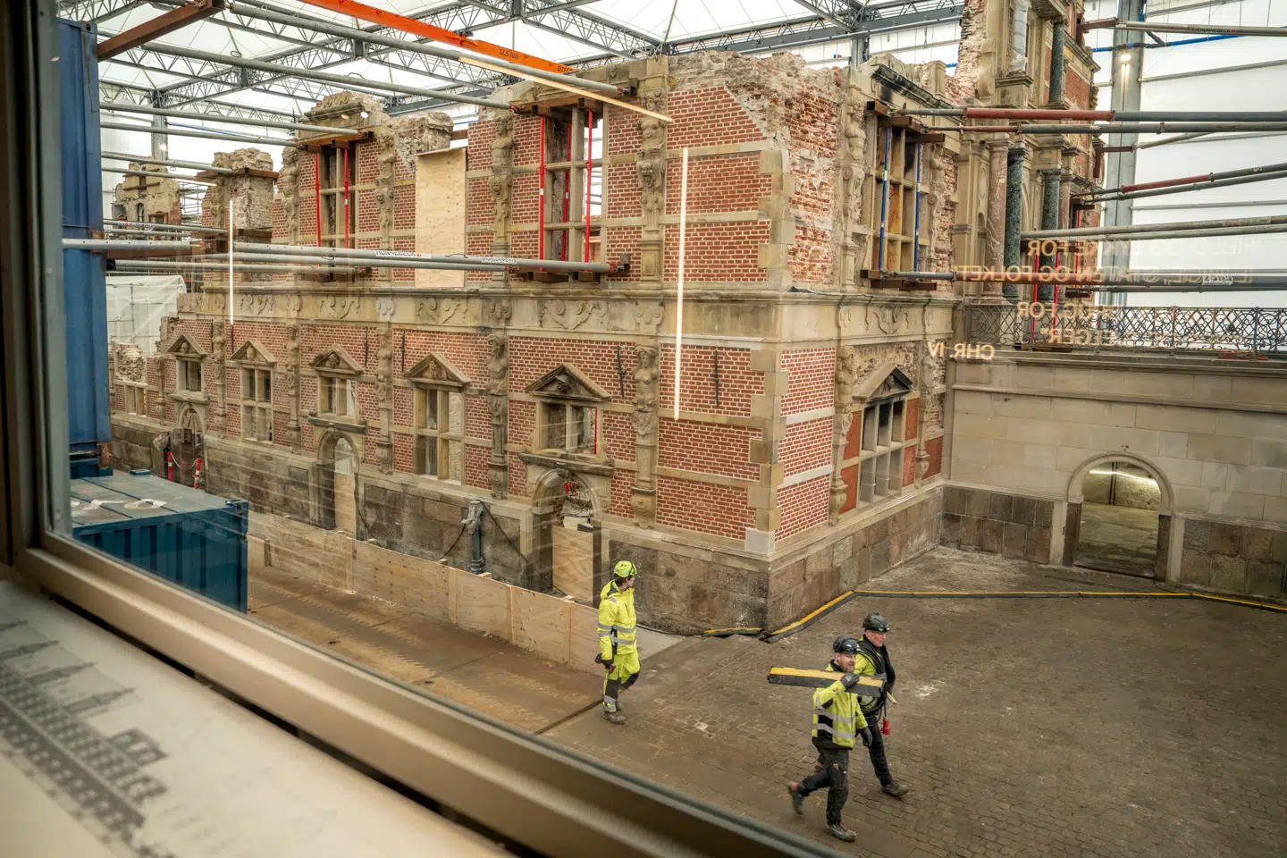 Kigget fra containerbygningen ind til ruinen af Børsen og håndværkerne, der arbejder på at genopbygge den, er besøgscentrets helt store attraktion.