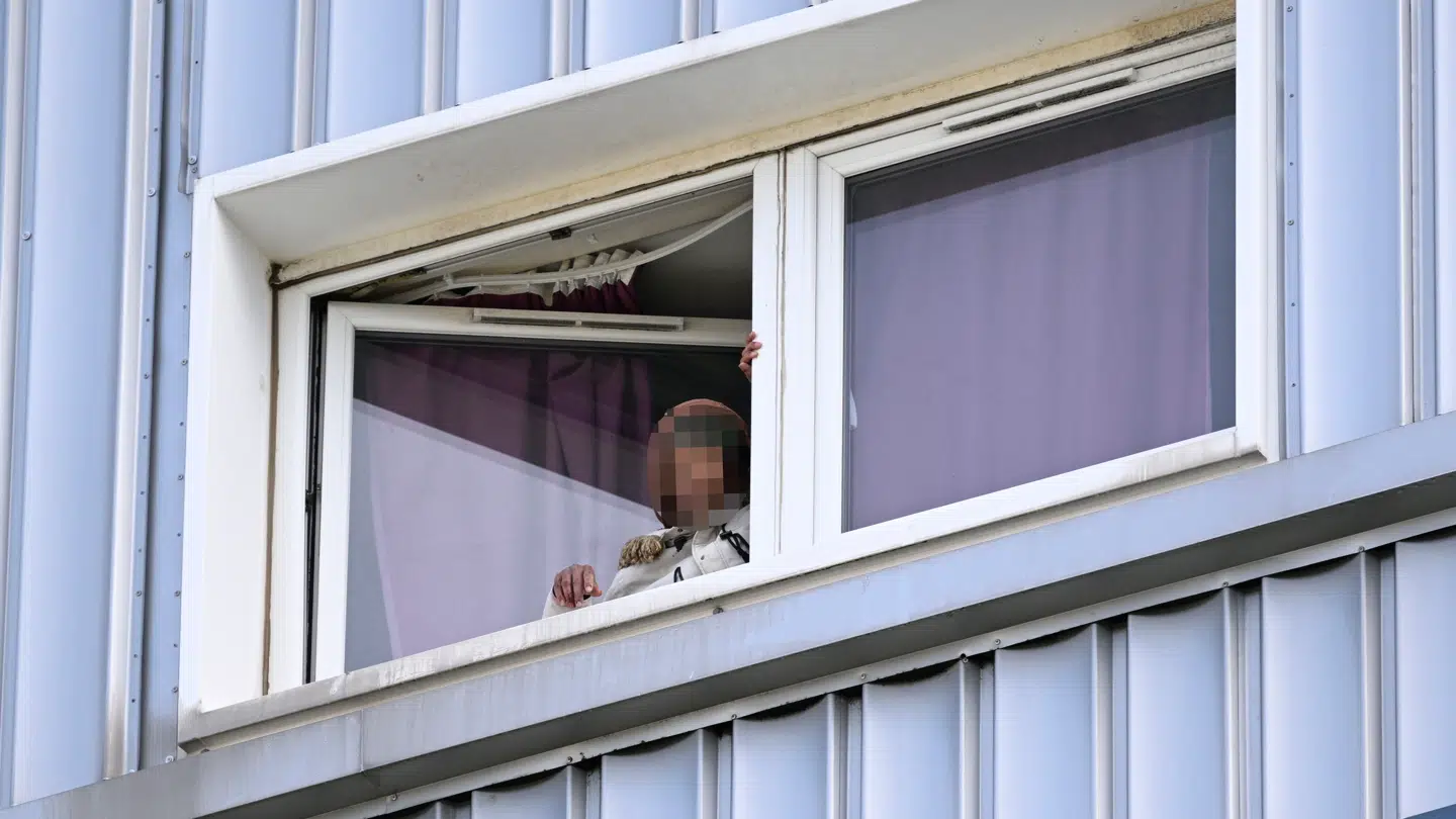 Den mistænkte er set ved et vindue under den igangværende konfrontation med politiet. Billedet er sløret af redaktionen.