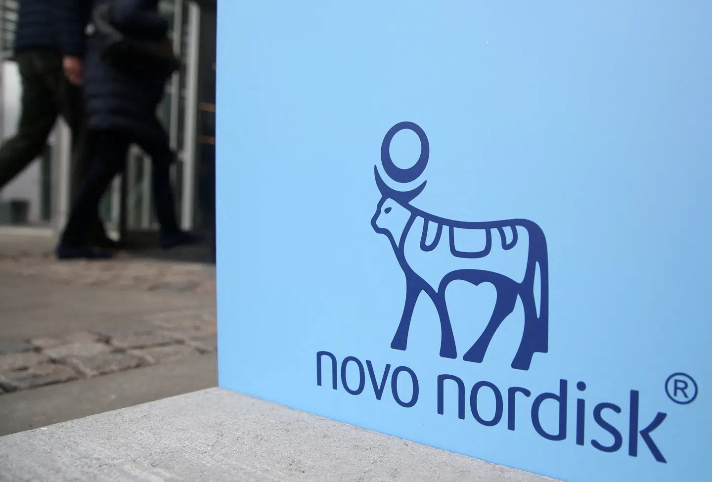 FILE PHOTO: People walk past a sign for Novo Nordisk's annual general meeting at the entrance to the venue in Copenhagen, Denmark, March 26, 2026. REUTERS/Tom Little/File Photo