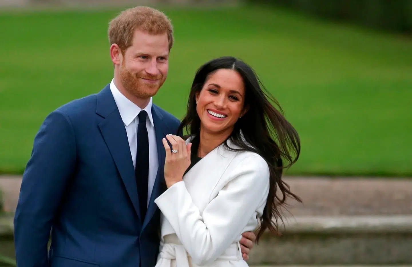 (FILES) In this file photo Britain's Prince Harry stands with his fiancée US actress Meghan Markle as she shows off her engagement ring whilst they pose for a photograph in the Sunken Garden at Kensington Palace in west London on November 27, 2017, following the announcement of their engagement. - Queen Elizabeth II and other senior British royals were gathering for a meeting Monday with Prince Harry in an attempt to solve the crisis triggered by his bombshell announcement that he and wife Meghan were stepping back from the royal frontline. Harry's father Prince Charles and brother Prince William, with whom he has strained relations, will join the monarch at her private Sandringham estate in eastern England, according to British media. (Photo by Daniel LEAL-OLIVAS / AFP)