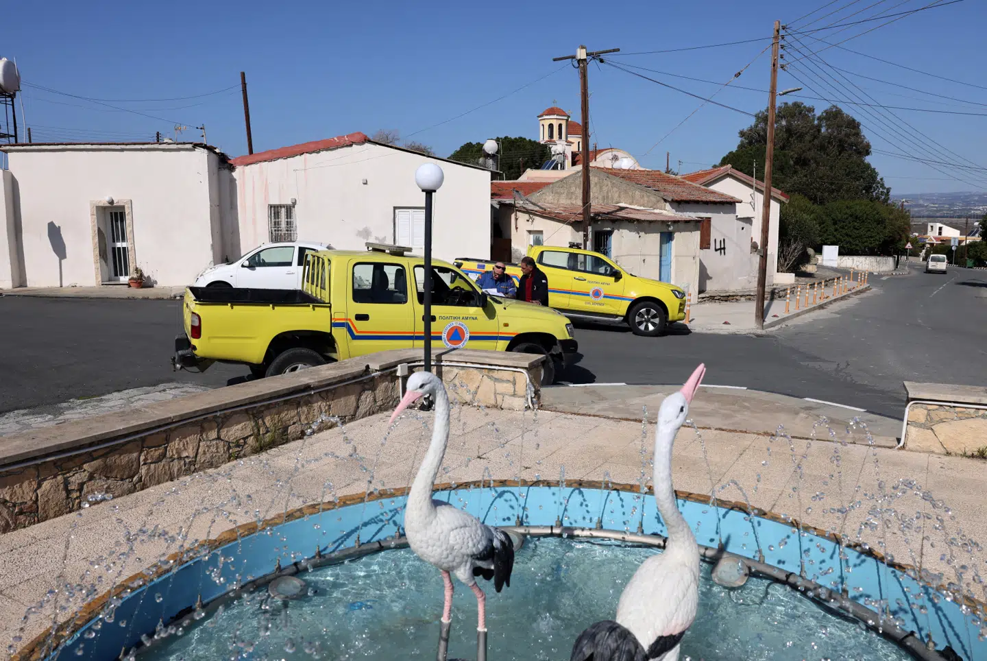 Civilforsvarsbetjente ses i Akrotiri landsby, dagen efter droneangrebet på basen.