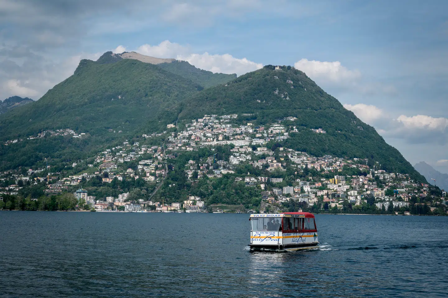 A taxi boat sails on Lake Lugano on May 7, 2019 near Lugano, southern Switzerland. Fabrice COFFRINI / AFP