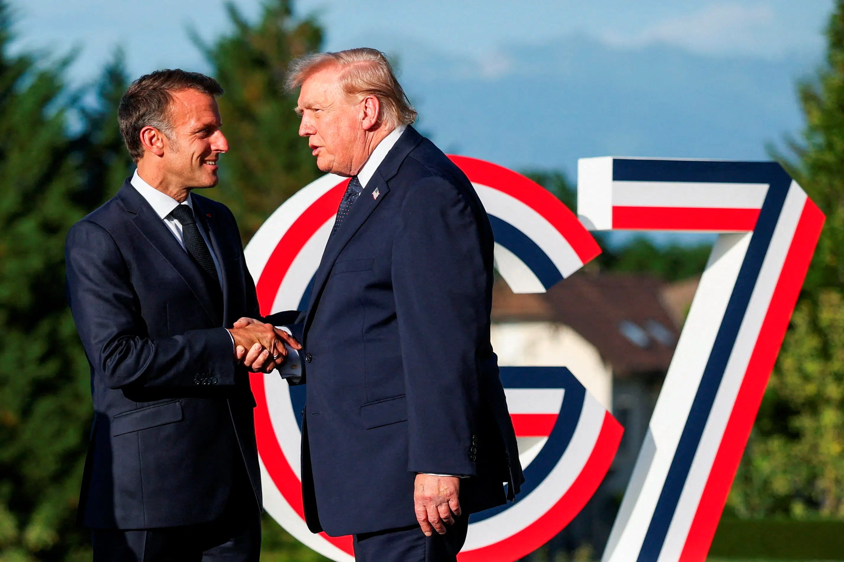 Trump arrives at French summit optimistic on Ukraine peace, but Putin call looms