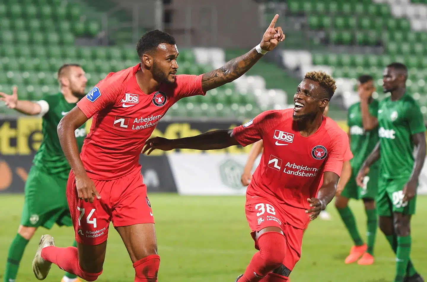 epa08627377 Junior Brumado (L) of FC Midtjylland celebrates with teammate Frank Ogochukwu (R) after scoring opening goal during the UEFA Champions League second qualifying round soccer match between Ludogorets Razgrad and FC Midtjylland in Razgrad, Bulgaria, 26 August 2020. EPA/VASSIL DONEV