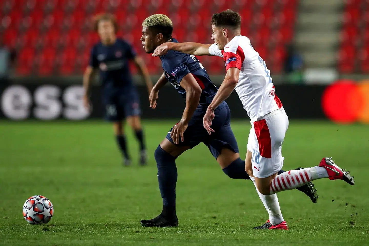 epa08689082 Evander of Midtjylland (L) in action against Lukas Masopust of Slavia (R) during the UEFA Champions League playoff first leg soccer match between Slavia Prague and FC Midtjylland in Prague, Czech Republic, 22 September 2020. EPA/MARTIN DIVISEK