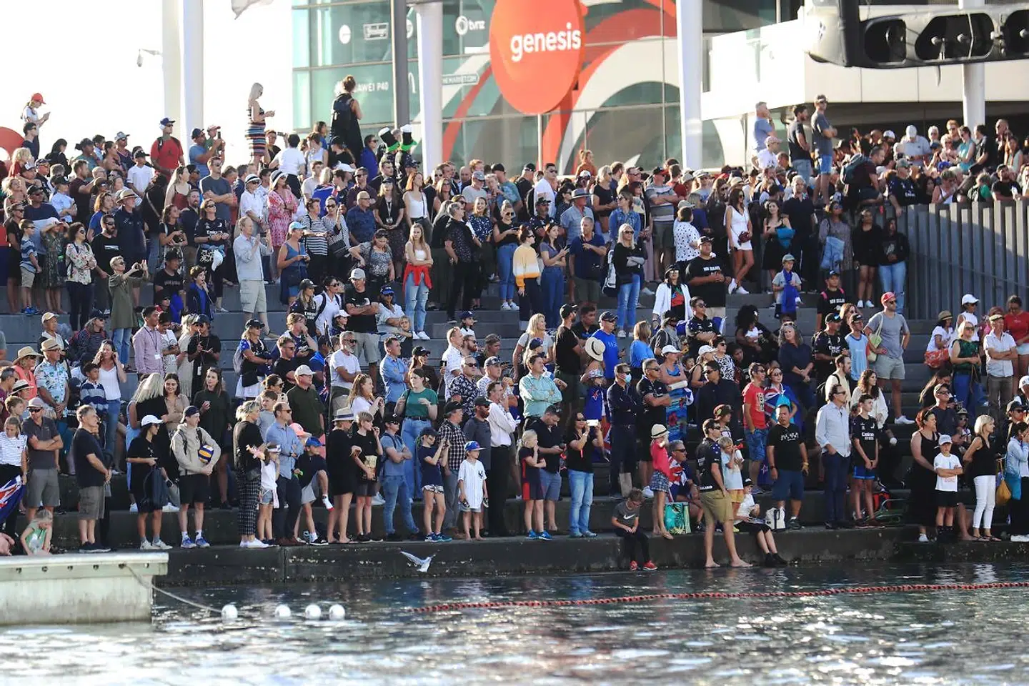 Spectators celebrate Team New Zealand's victory in the 36th America's Cup against Luna Rossa Prada in Auckland on March 17, 2021. (Photo by Gilles Martin-Raget / AFP)