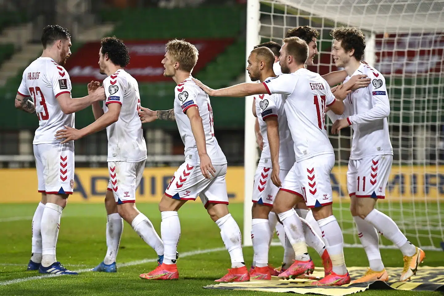 epa09109371 Denmark's Jonas Win (R) celebrates with teammates after scoring the 1-0 lead during the FIFA World Cup 2022 qualifying soccer match between Austria and Denmark in Vienna, Austria, 31 March 2021. EPA/Christian Bruna