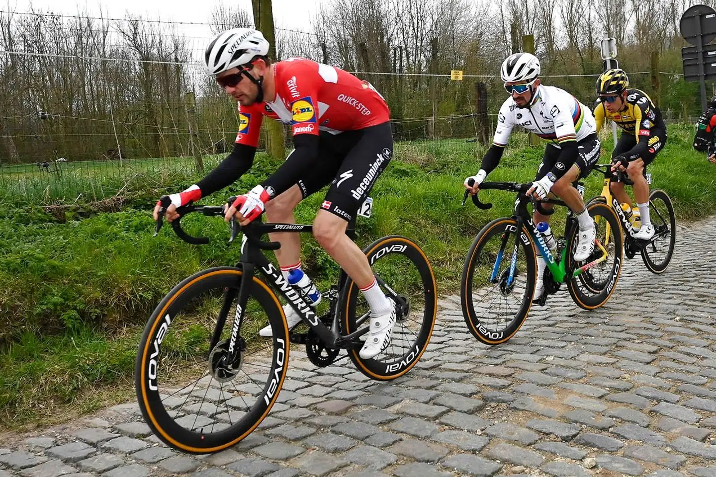 Danish Kasper Asgreen of Deceuninck-Quick-Step, French Julian Alaphilippe of Deceuninck-Quick-Step and Belgian Wout Van Aert of Team Jumbo-Visma team compete on the Molenberg in the 105th edition of the "Ronde van Vlaanderen, Tour of Flanders" one day cycling race, from Antwerp to Oudenaarde, on April 4, 2021. (Photo by DIRK WAEM / various sources / AFP) / Belgium OUT