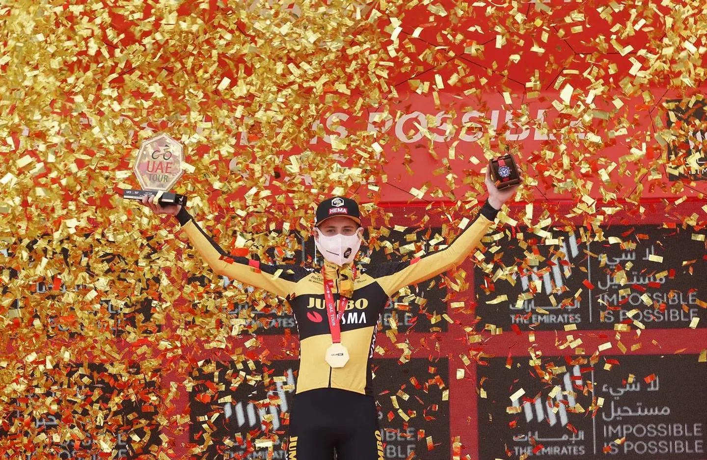 Jonas Vingegaard of Jumbo Visma team celebrates on the podium after winning the fifth stage of the UAE Cycling Tour from Fujairah Marine Club to Jebel Jais on February 25, 2021. (Photo by Giuseppe CACACE / AFP)